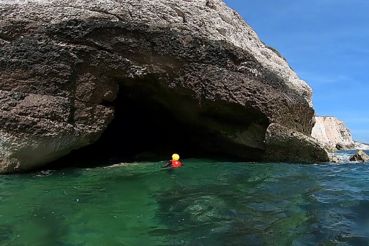 a close up of a rock next to water