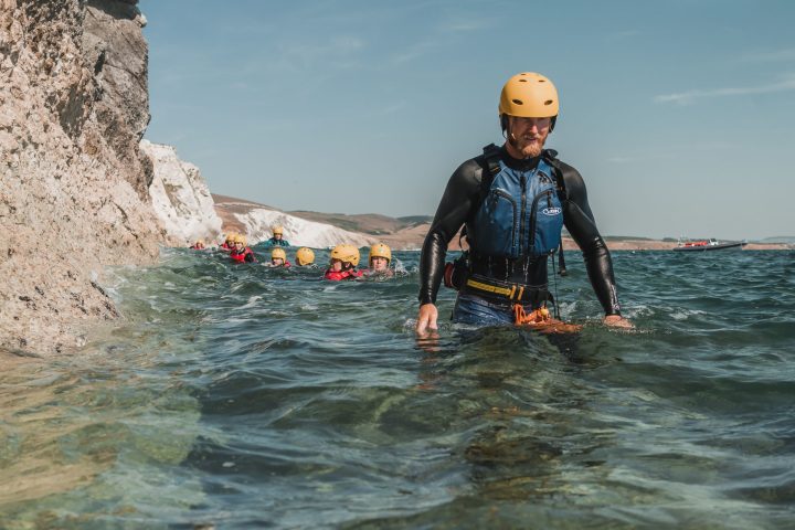 a young girl riding a wave on top of a body of water