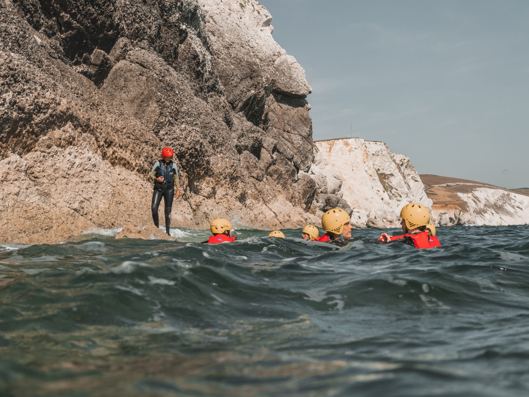 a group of people riding on the back of a boat in the water