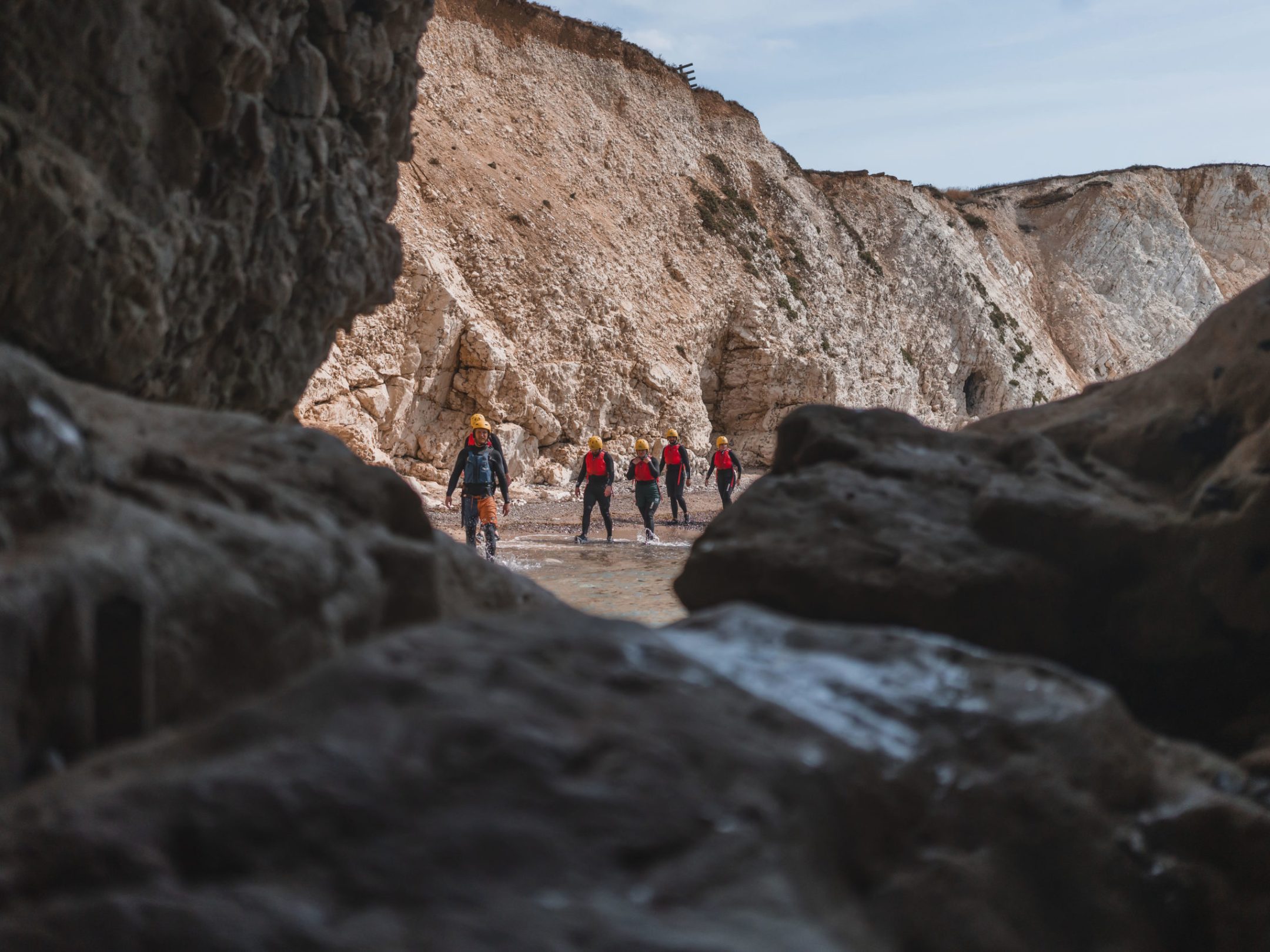 a group of people standing on a rocky hill