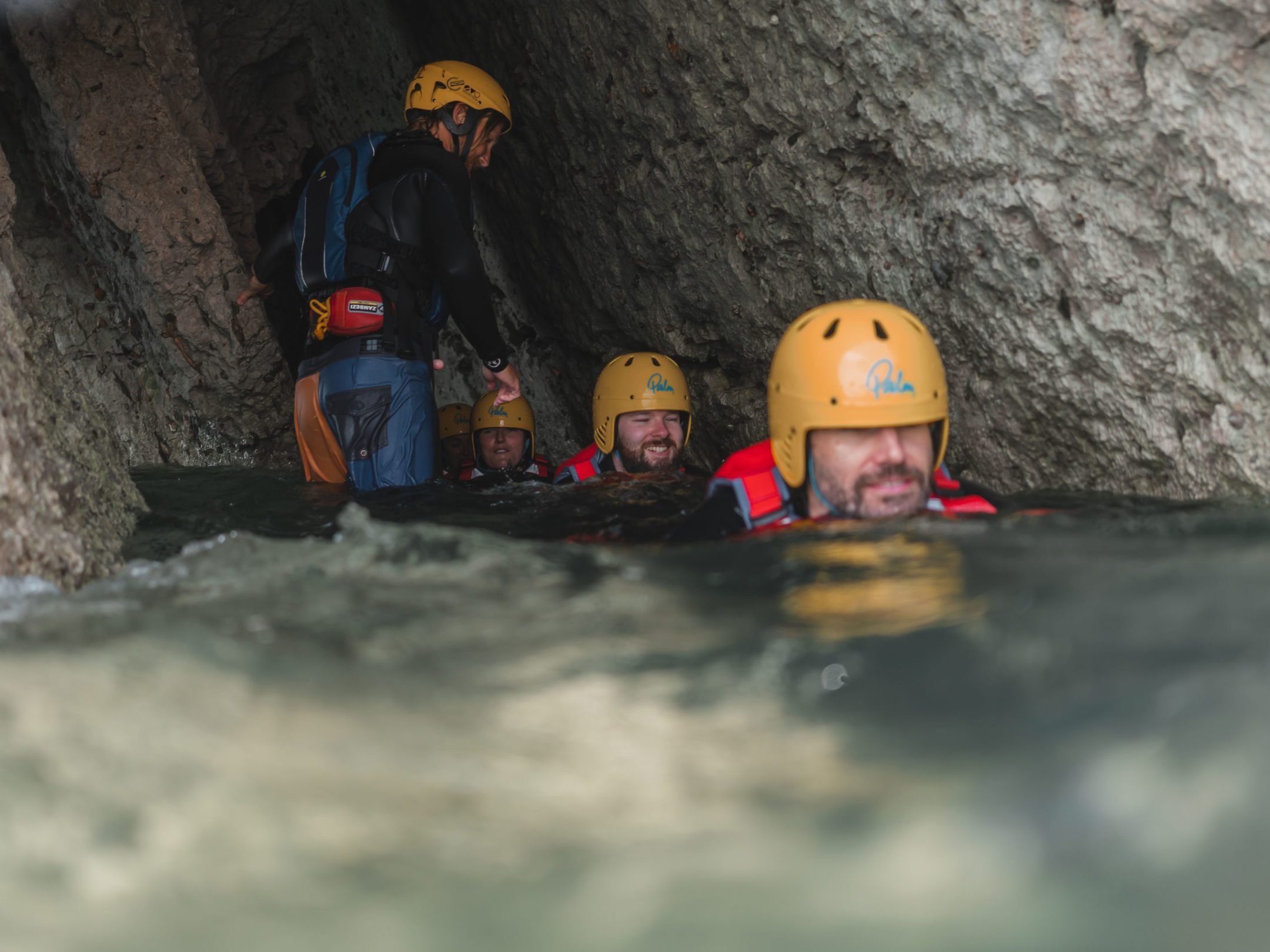 a man riding a snow board on a rock