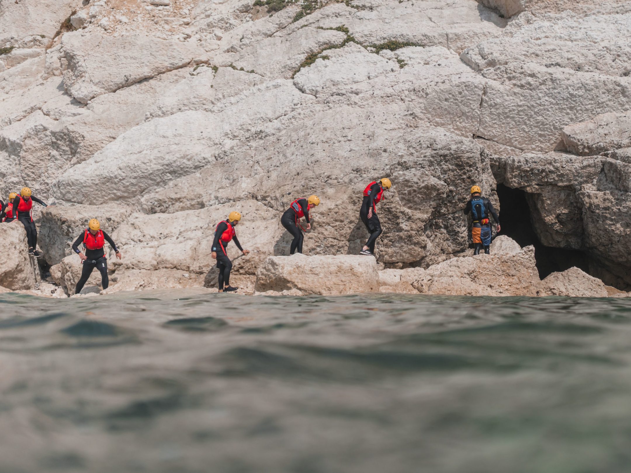 a group of people walking in the sand